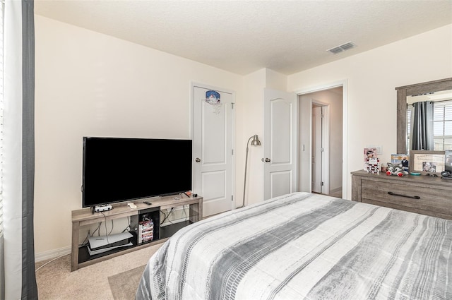 bedroom with a textured ceiling and carpet