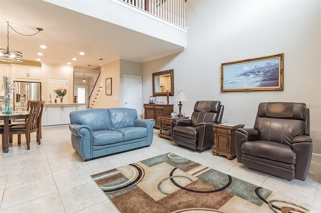 living room with ornamental molding and light tile patterned floors