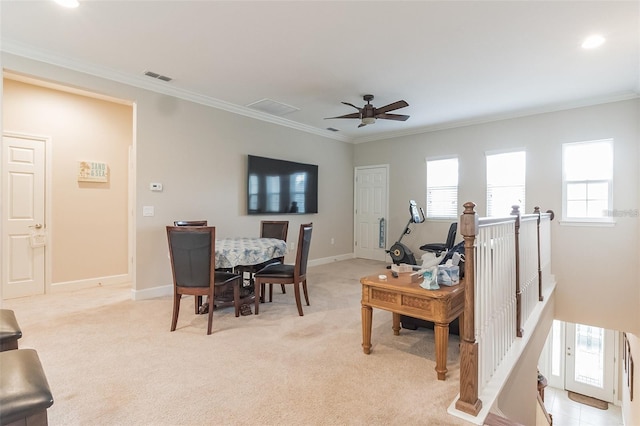 carpeted living room featuring ceiling fan and ornamental molding