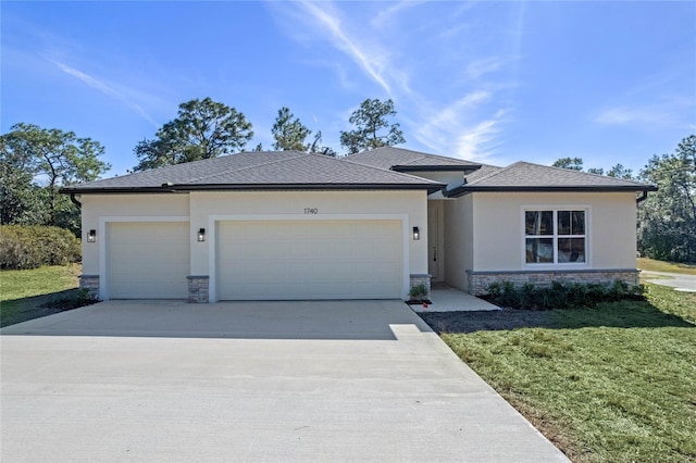 view of front of home featuring a garage and a front lawn