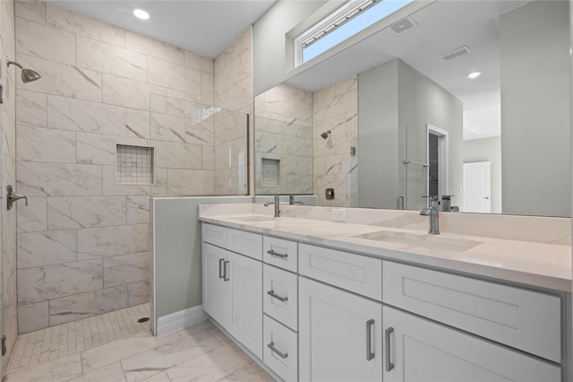 bathroom with a shower with shower door and vanity