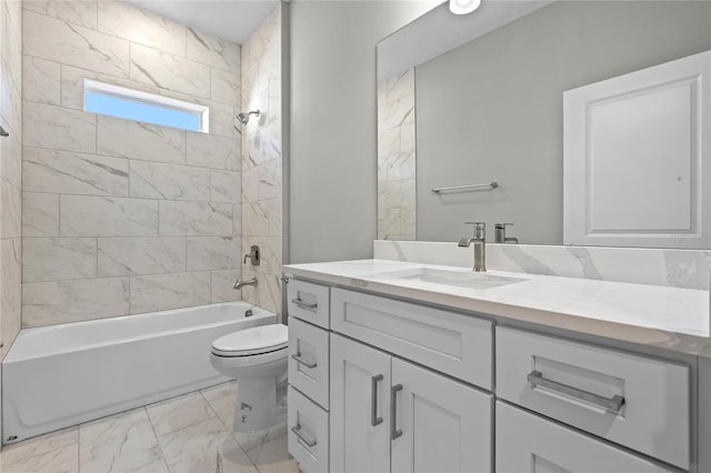 full bathroom with vanity, toilet, and tiled shower / bath