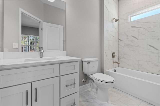 full bathroom featuring tiled shower / bath combo, vanity, and toilet