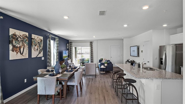 dining room with wood-type flooring and sink