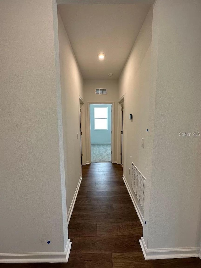 hallway featuring dark hardwood / wood-style flooring