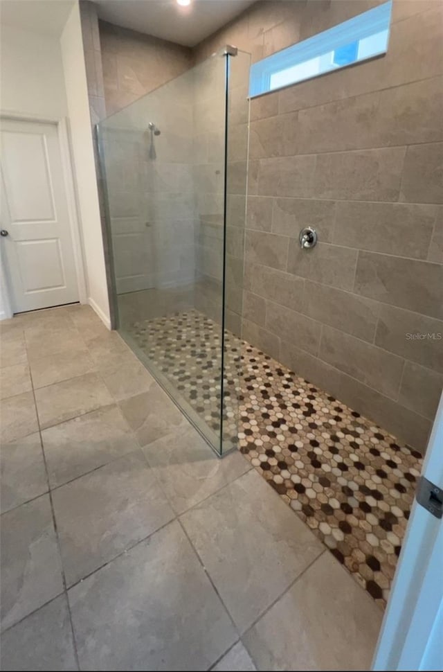 bathroom with tiled shower