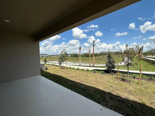 view of yard with a rural view and a patio area