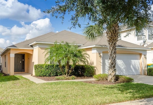 view of front of home with a garage and a front yard