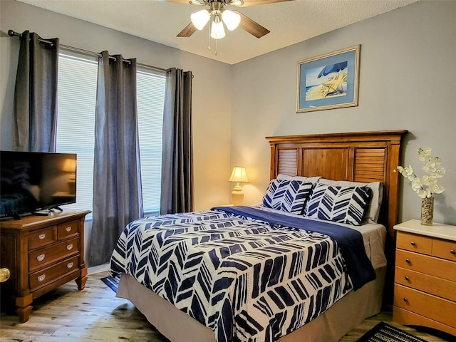 bedroom with ceiling fan and light hardwood / wood-style floors