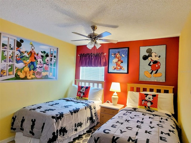 bedroom with a textured ceiling and ceiling fan