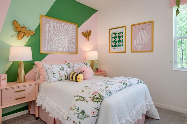 carpeted bedroom featuring multiple windows and baseboards