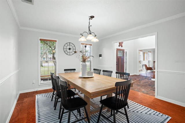 dining space featuring dark wood-type flooring and crown molding