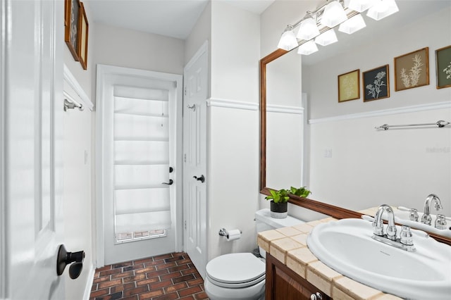 bathroom with toilet and vanity