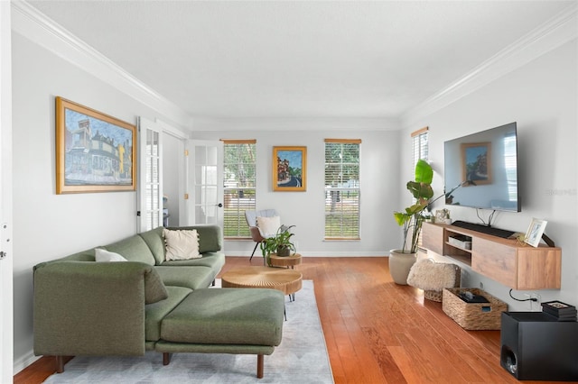 living room with ornamental molding and light hardwood / wood-style floors