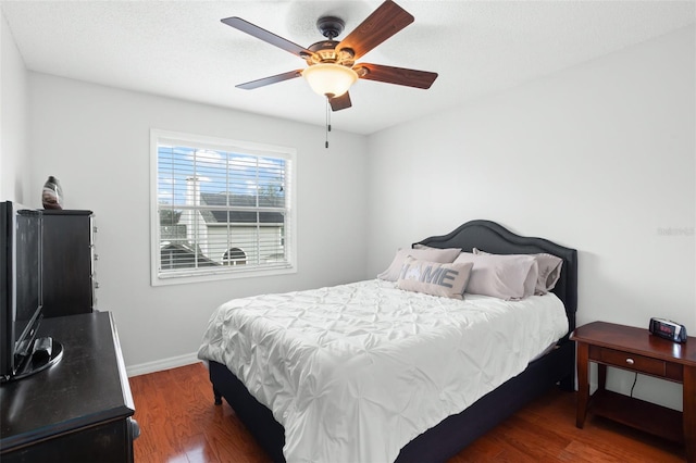 bedroom with dark wood-type flooring and ceiling fan