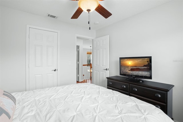 bedroom with ceiling fan and a closet