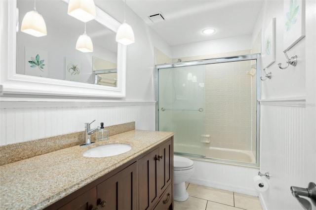 full bathroom with toilet, bath / shower combo with glass door, tile patterned floors, and vanity