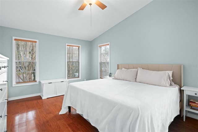 bedroom featuring ceiling fan, multiple windows, hardwood / wood-style flooring, and lofted ceiling