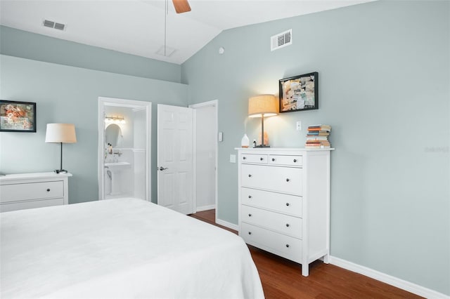 bedroom featuring ceiling fan, ensuite bath, vaulted ceiling, and dark hardwood / wood-style floors