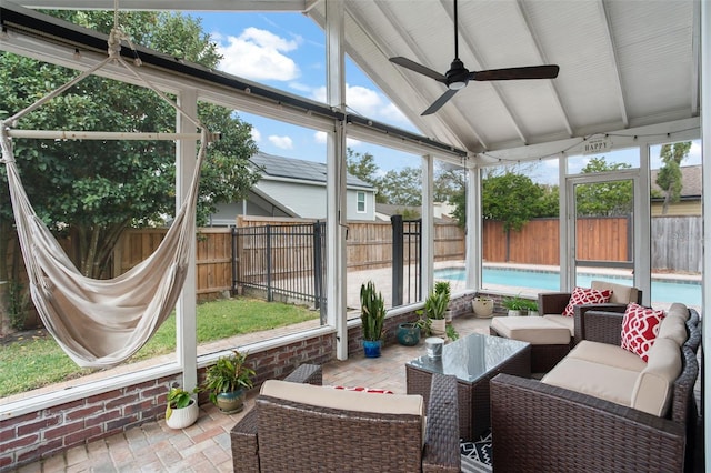 sunroom / solarium featuring ceiling fan and lofted ceiling