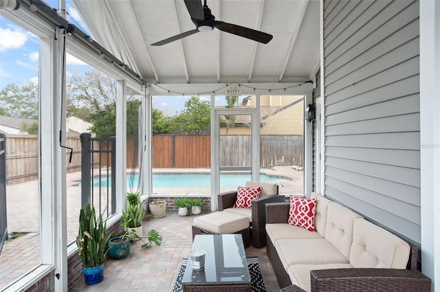 sunroom / solarium featuring ceiling fan and vaulted ceiling