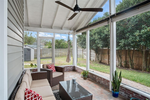 sunroom with ceiling fan and vaulted ceiling