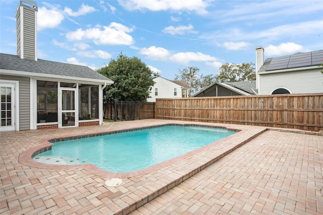 view of pool featuring a sunroom and a patio