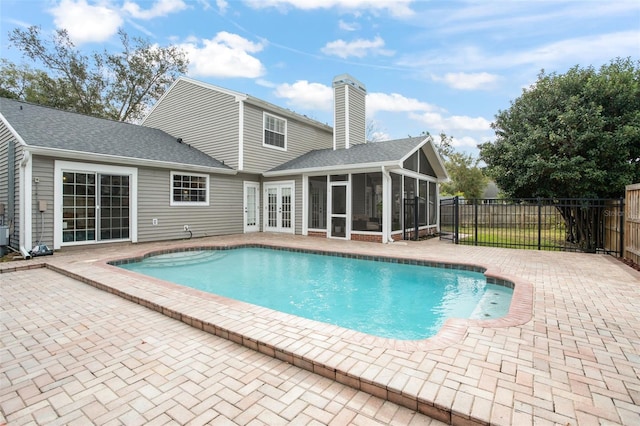 view of swimming pool featuring a patio area and a sunroom