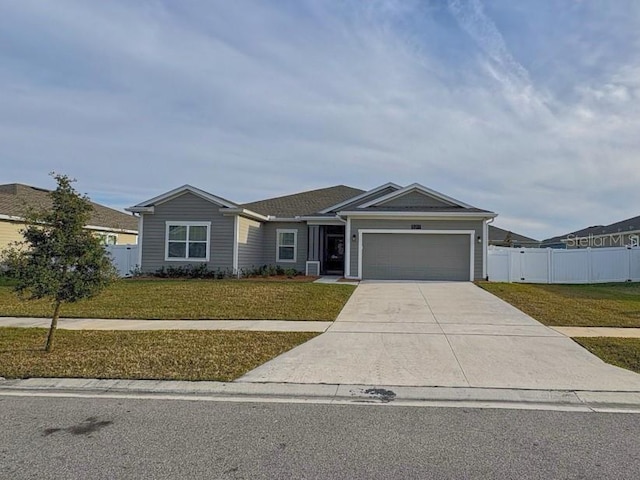 ranch-style house featuring a front lawn and a garage