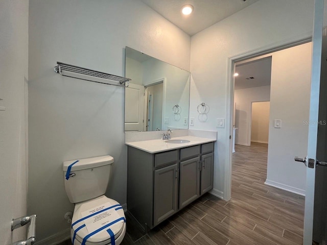 bathroom with toilet and vanity