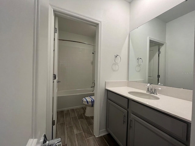 full bathroom with toilet, vanity, and shower / washtub combination