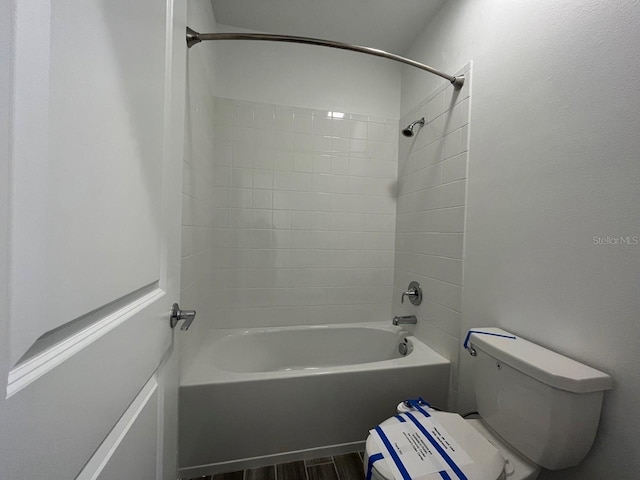 bathroom with toilet,  shower combination, and hardwood / wood-style flooring