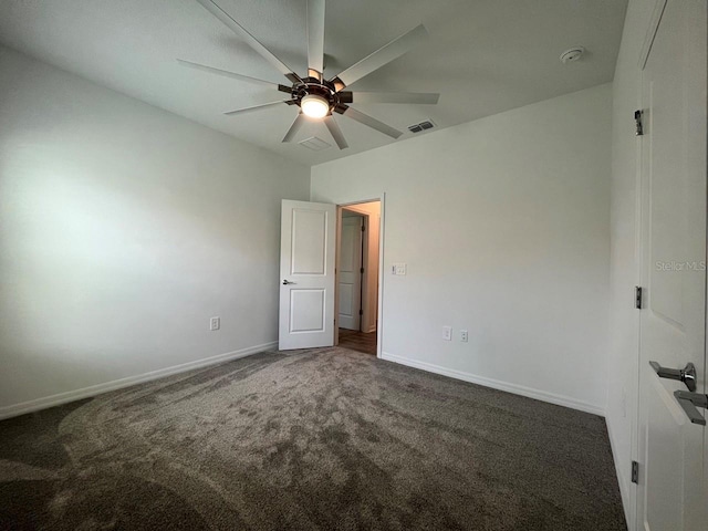 unfurnished bedroom with ceiling fan and dark carpet