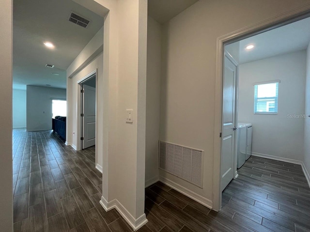 corridor featuring separate washer and dryer and plenty of natural light