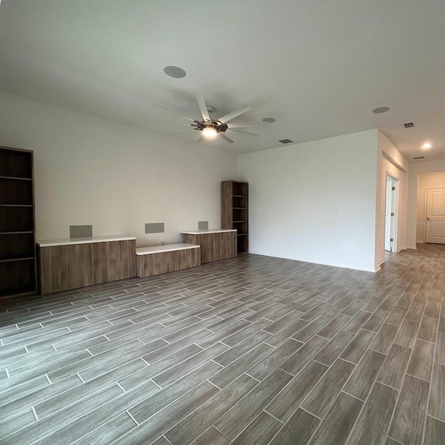 unfurnished living room featuring ceiling fan