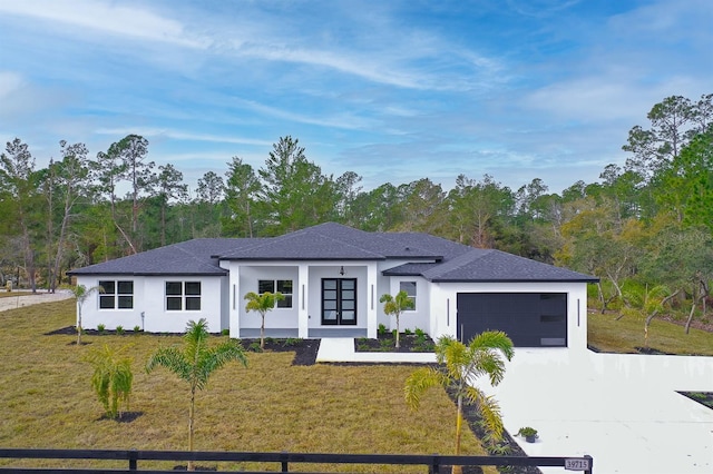 view of front of property featuring a front yard and a garage