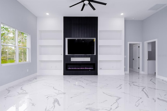 living room featuring ceiling fan, built in features, and a fireplace