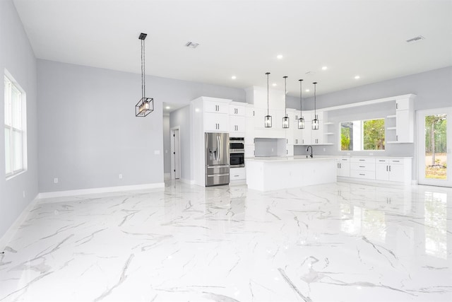 kitchen with stainless steel refrigerator with ice dispenser, sink, hanging light fixtures, an island with sink, and white cabinets