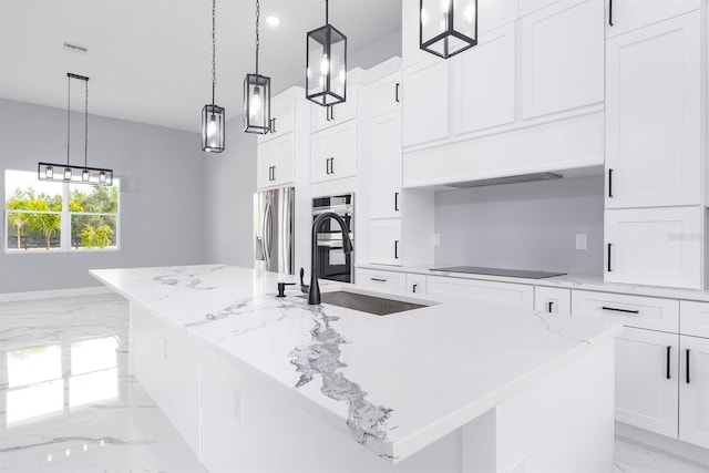 kitchen with a large island, pendant lighting, white cabinets, and appliances with stainless steel finishes