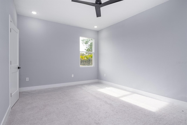 carpeted spare room with ceiling fan