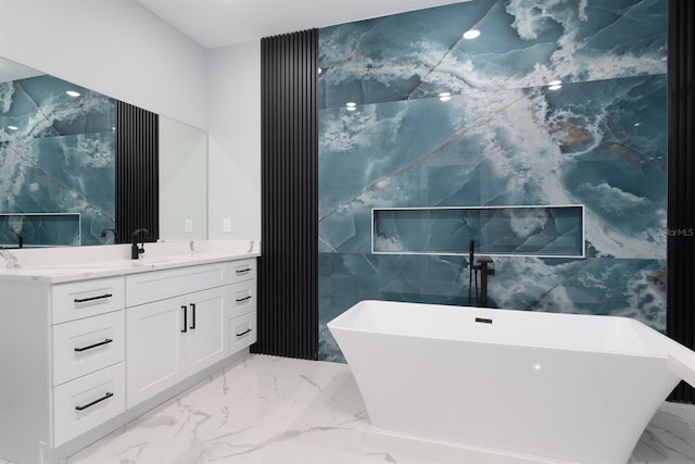 bathroom featuring a washtub, vanity, and tile walls