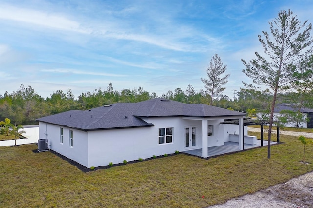 back of property with a patio, a lawn, and central air condition unit