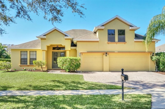 view of front of home featuring a garage and a front lawn