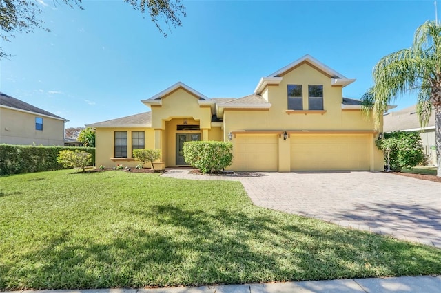 view of front of home with a front yard and a garage