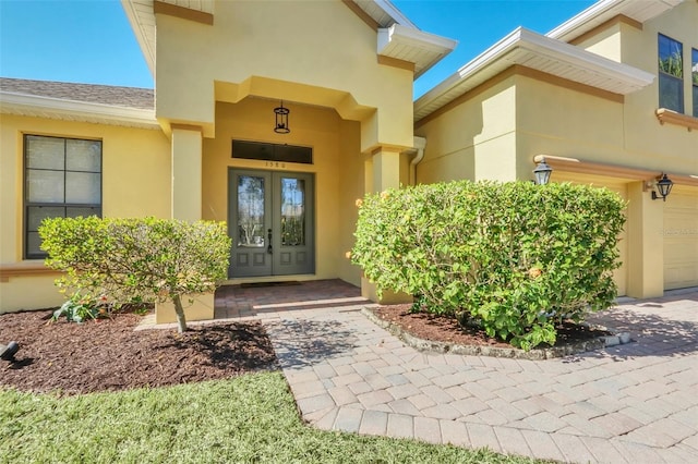 property entrance with a garage and french doors