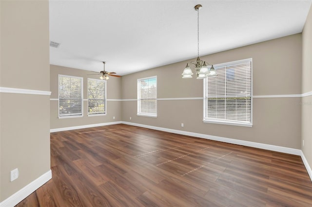 unfurnished room with dark wood-type flooring and ceiling fan with notable chandelier