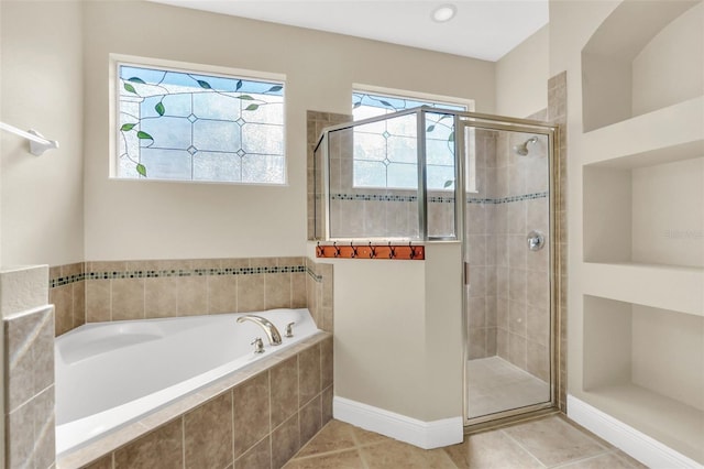 bathroom with separate shower and tub and tile patterned flooring