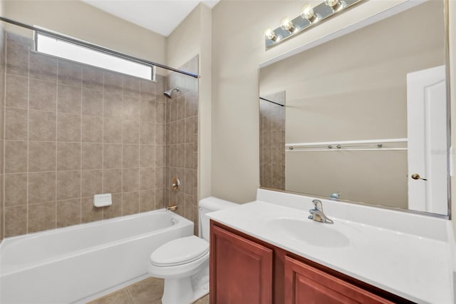 full bathroom featuring toilet, tiled shower / bath, tile patterned flooring, and vanity