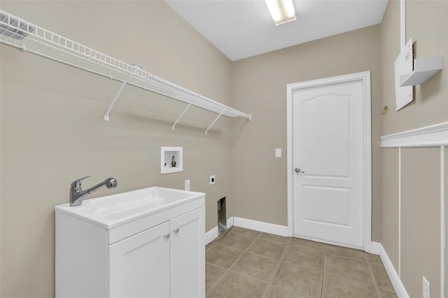 laundry area with hookup for an electric dryer, light tile patterned flooring, washer hookup, cabinets, and sink