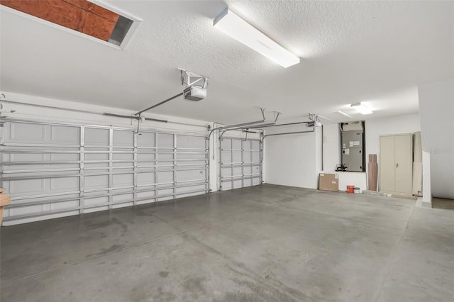 garage featuring a garage door opener and heating unit